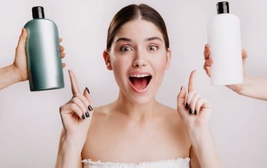 Mujer en toalla eligiendo entre dos productos de belleza